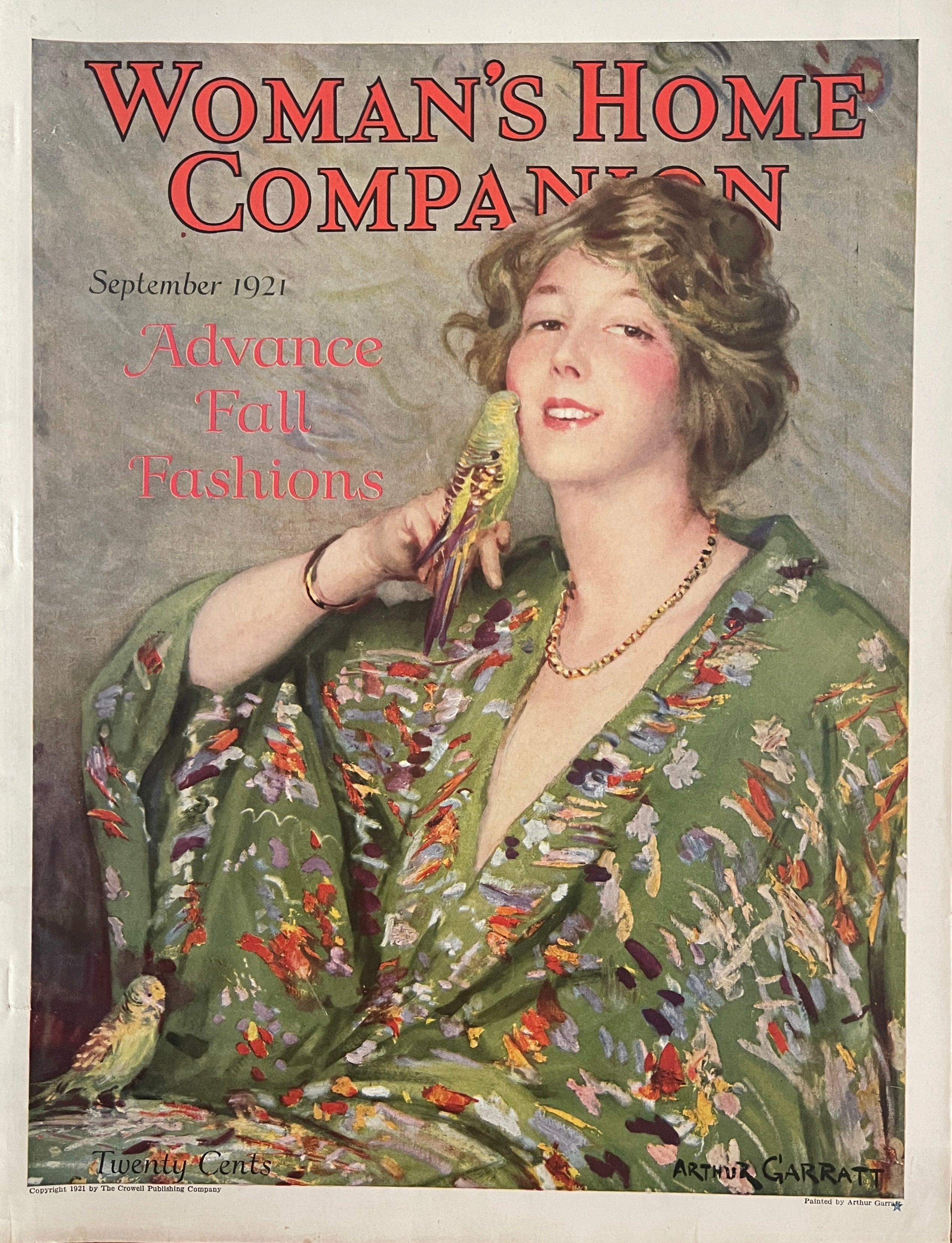 1921 Woman’s Home Companion cover only, Advance Fall Fashions, illustrated woman holding a small bird, Arthur Garratt